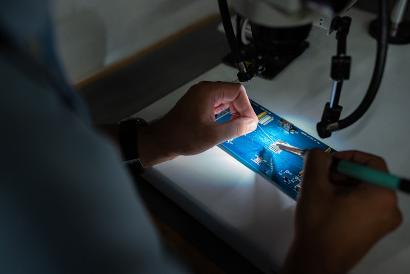 Technician inspecting circuit board